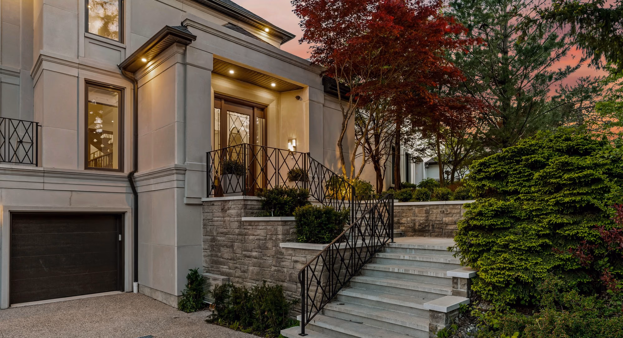 Home exterior with landscaped garden and steps at dusk