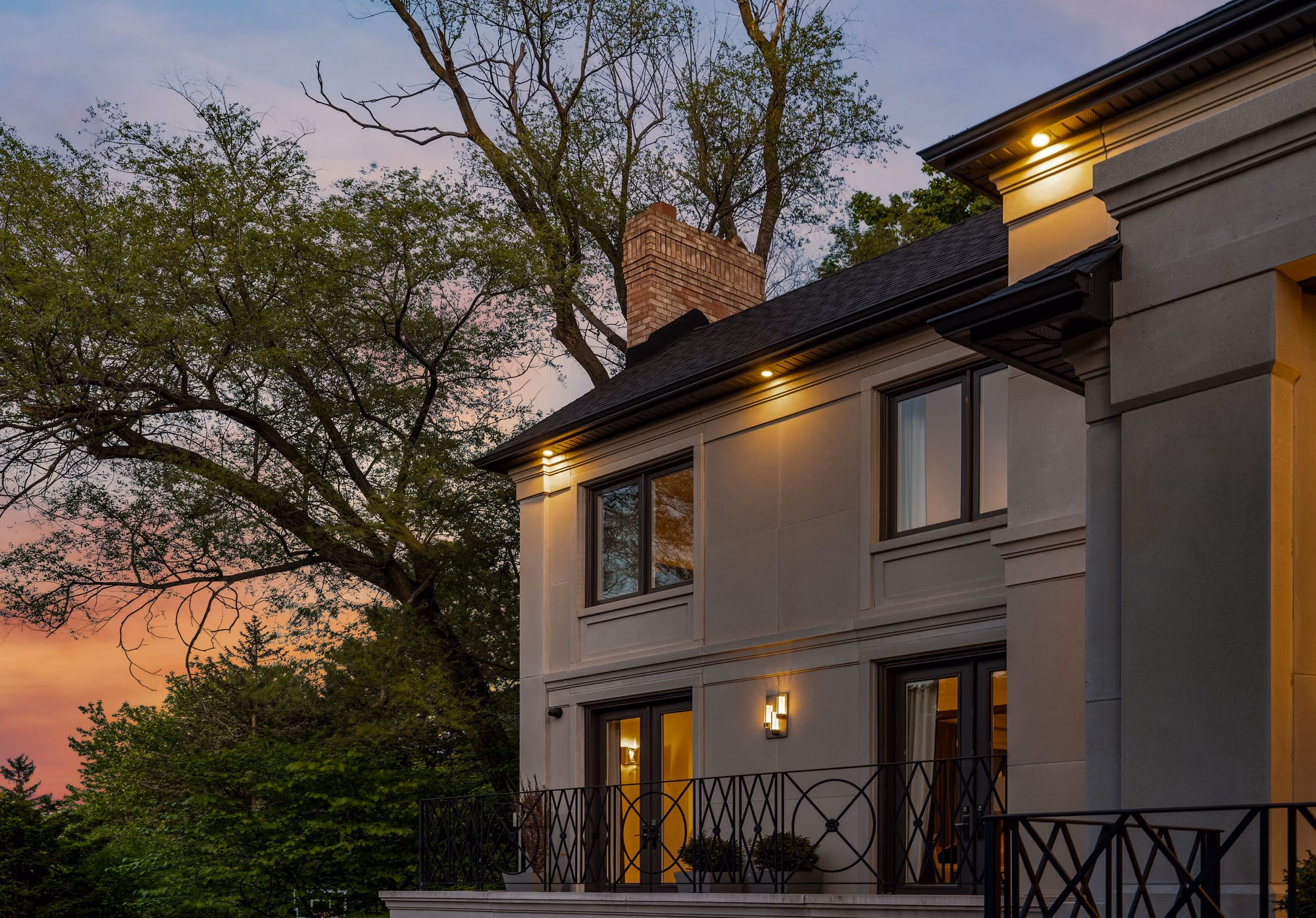 Home exterior at dusk with warm accent lighting